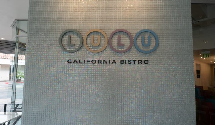 Sign on a tiled wall reads "Lulu California Bistro" with colorful circular designs around the letters "LULU.