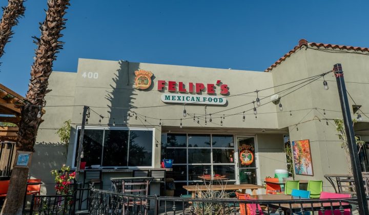 Exterior of Felipe's Mexican Food restaurant with outdoor seating and string lights on a sunny day.