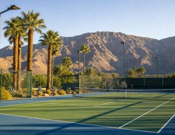 Public tennis courts in the Coachella Valley desert with mountain backdrop