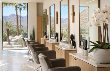 Bright hair salon styling stations with desert mountain views