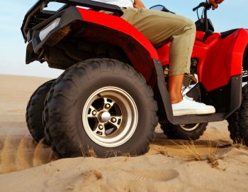man-in-helmet-rides-on-atv-in-desert-action-view-2024-11-30-00-00-24-utc-1-1