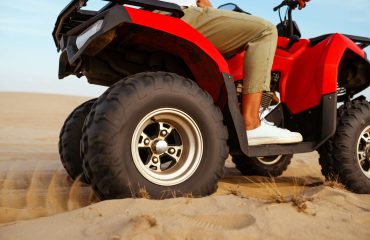 man-in-helmet-rides-on-atv-in-desert-action-view-2024-11-30-00-00-24-utc-1-1
