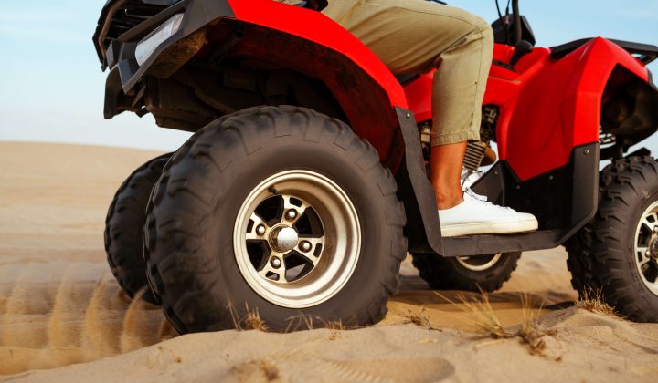man-in-helmet-rides-on-atv-in-desert-action-view-2024-11-30-00-00-24-utc-1-1